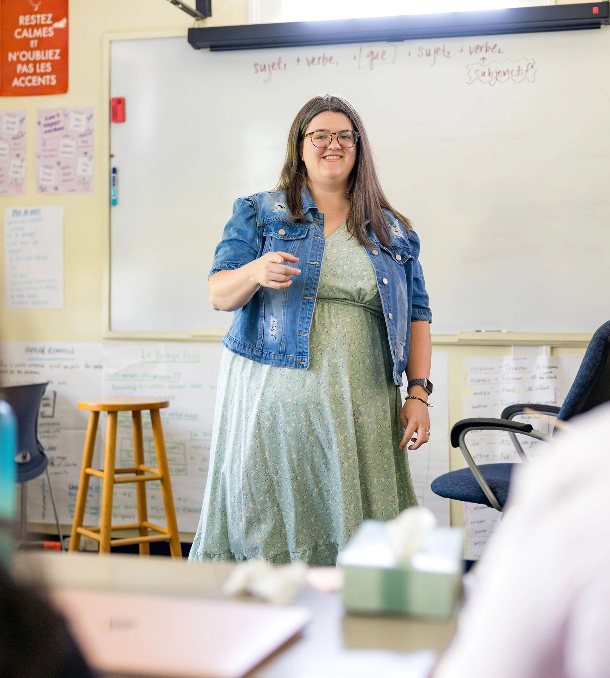 teacher standing at the front of a classroom talking to students at Miss Porter's School